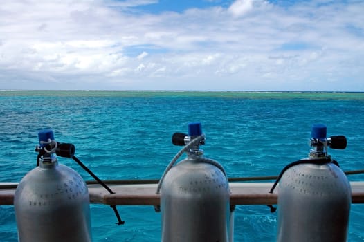 three scuba cylinders, green water, great barrier reef