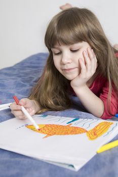 little cute smiling girl seven years old with drawing picture