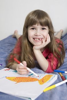 little cute smiling girl seven years old with drawing picture