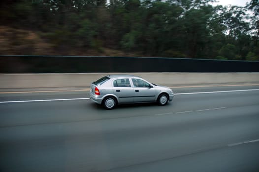 single car going on highway, motion blur