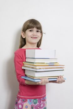 little cute girl seven years old  carry books. White background