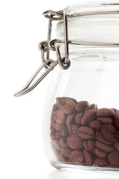 Coffee beans in a glass tight closed cup isolated over white background.