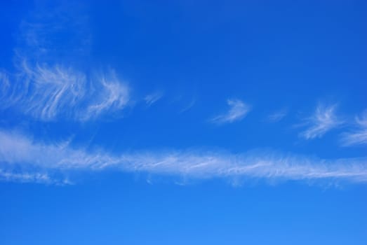 Blue sky with two horizontal white cloud stripes.