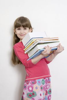 little cute girl seven years old carry books. White background