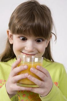 little cute girl drink orange juice