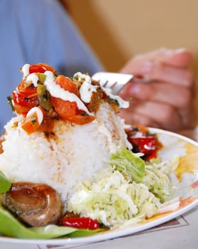 appetizing rice dinner served, mushroom on fork