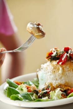 appetizing rice dinner served, mushroom on fork