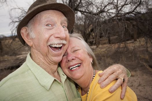 Happy Senior Couple Outdoors Smiling and Laughing