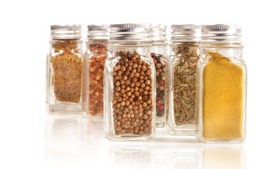 Assorted spice jars isolated on white background