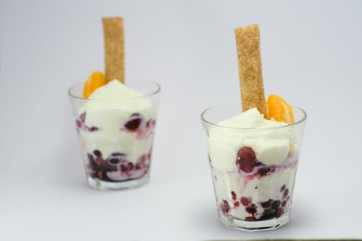 Dessert with whipped cream in a glass on a white background