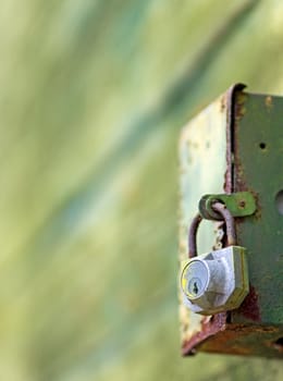 Locked rusted box on abstract background