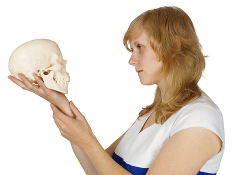 A woman examines a human skull isolated on white background