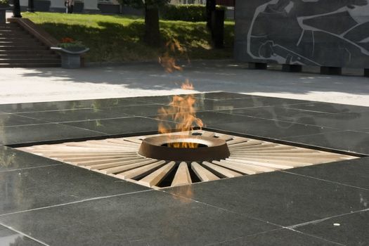 Monument to defenders with lighted fire on the area