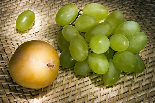 Still-life with grapes and plum on a tray