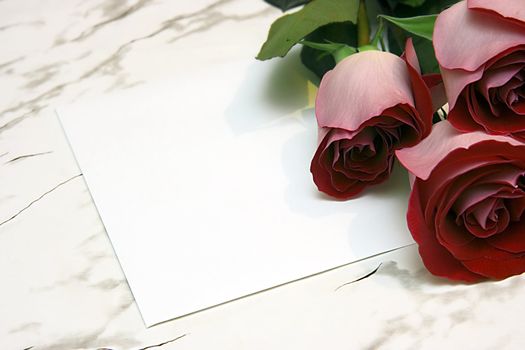 Three red roses and note on a marble table