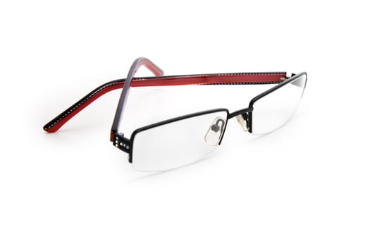 glasses with a red and black frame lie on a white table