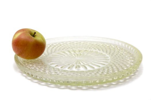 Unique apple on the big plate on a white background