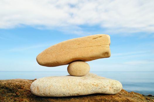 Small white pebble between two stones on the seashore