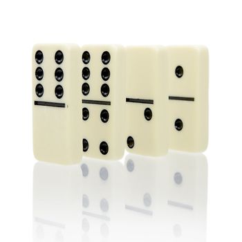 Four dominoes stand on a white background