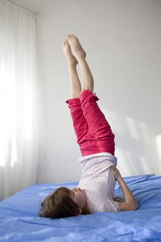 young smiling cute girl standing at head. Upside-down