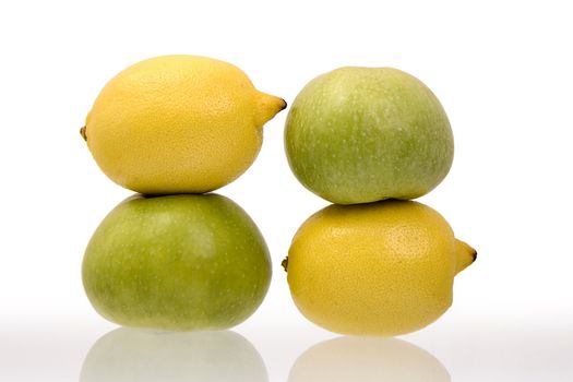 Two lemons and two green apples on a white background