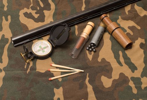 Subjects of the hunting ammunition on a camouflage fabric.