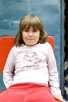 portrait young cute girl sitting on chair