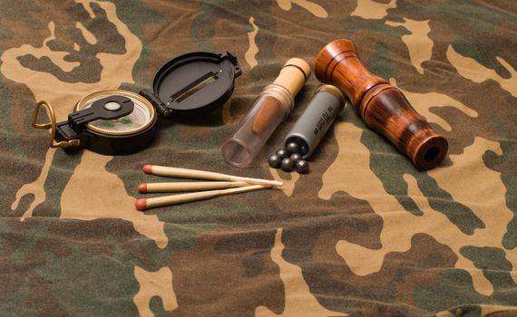 Subjects of the hunting ammunition on a camouflage fabric.