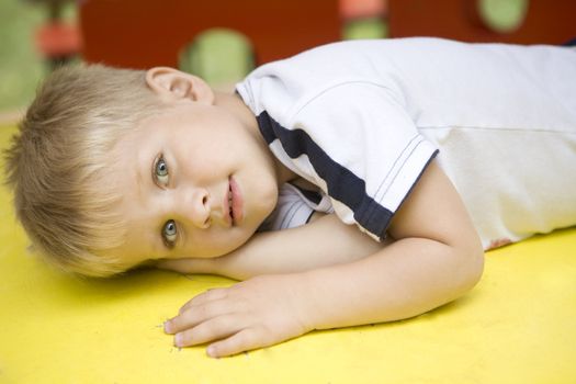 Little cute blond boy four years old  lying