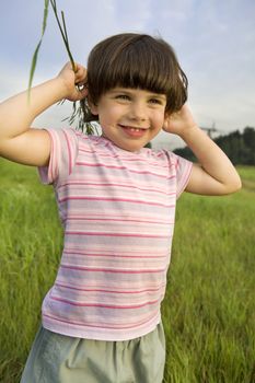 little cute pensive girl five years old standing on the park 