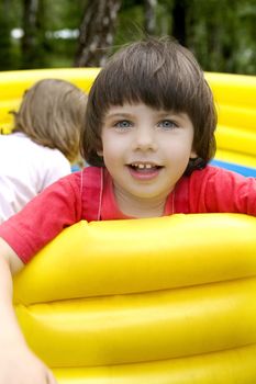 little cute smiling girl in rubber trampoline