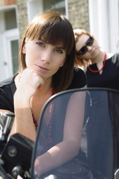 Young woman sitting on motorcycle. Summer time