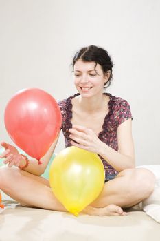 young attractive woman doing exercise with balloon in gym