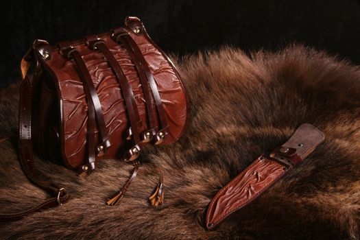 Bag and sheath on a skin of a bear