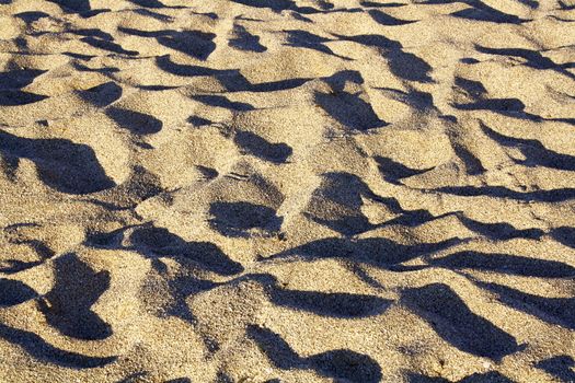 Waves of beach sand. Summer background.