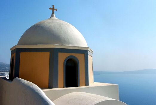 Looking across a Greek Orthadox Church in Santorini, Greece at the caldera.