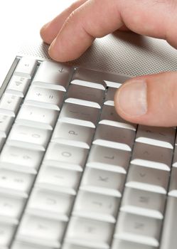 Man finger above the laptop delete key
