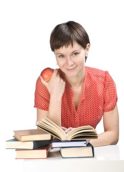 Young women with apple and books on white background