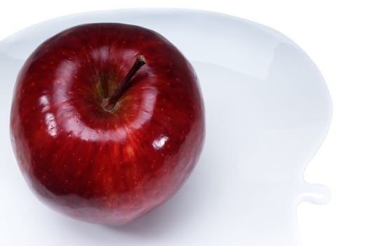 red apple on a apple shaped dish isolated over white