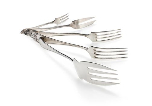 Silver forks set setout on a white background