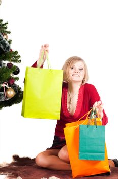 Happy woman with Christmas presents and tree isolated on white