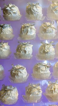 Arranged white candy, purple background