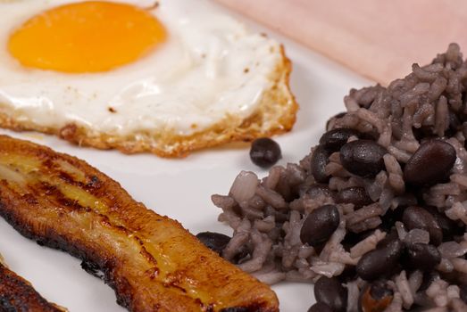 Hearty central american breakfast, gallo pinto with ham and egg
