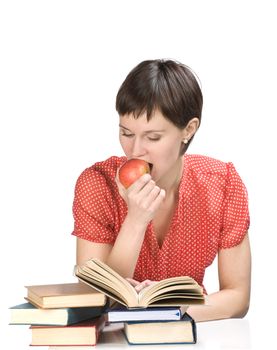 Young women with apple and books on white background