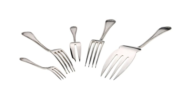 Silver forks set setout on a white background. With clipping path.