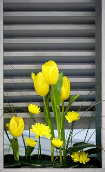 Yellow flowers near the metal ventilation grilles