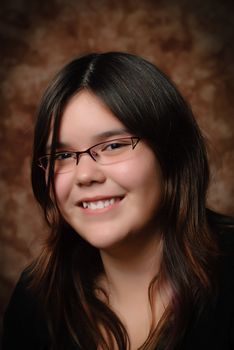 A young preteen girl smiling for her portrait