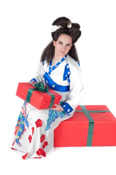 Portrait of the girl of the Asian appearance with a make-up under the geisha on a white background