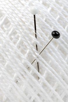 Macro shot of tailors pin embed in cotton
