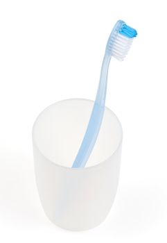 Blue toothbrush in glass. With clipping path.